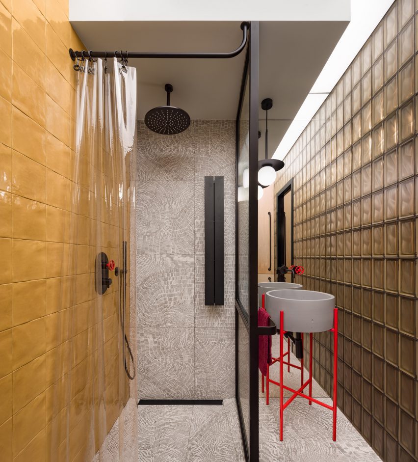 Bathroom with yellow tiles and glass brick wall Ukraine