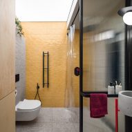 Bathroom in Dihome designed apartment with yellow walls