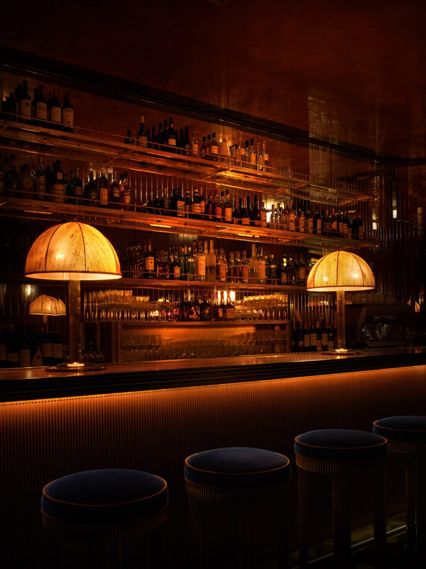 Brass accents feature throughout, on lampstands at the bar