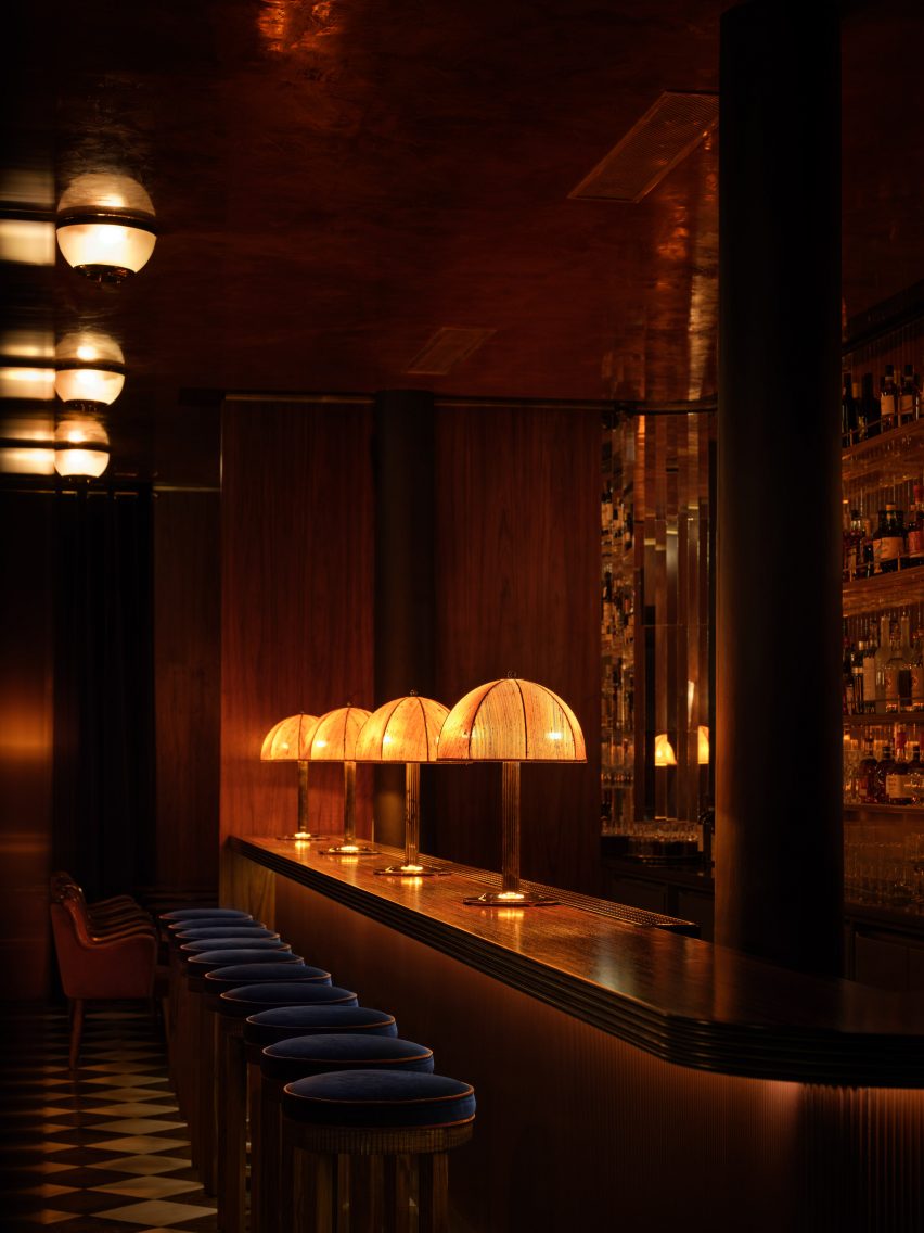 Dimly lit bar with lampshades and long bar