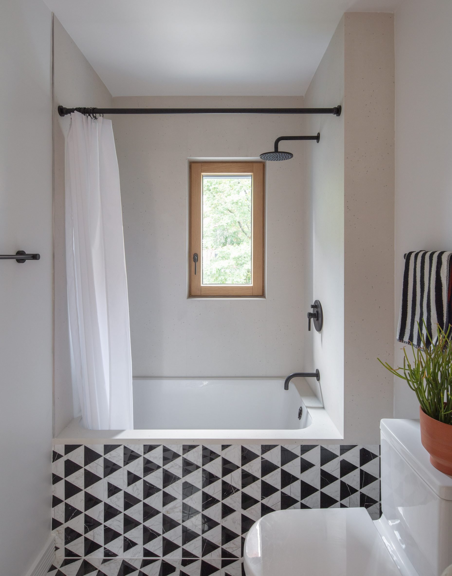 Bathroom with black and white tiles and fixtures