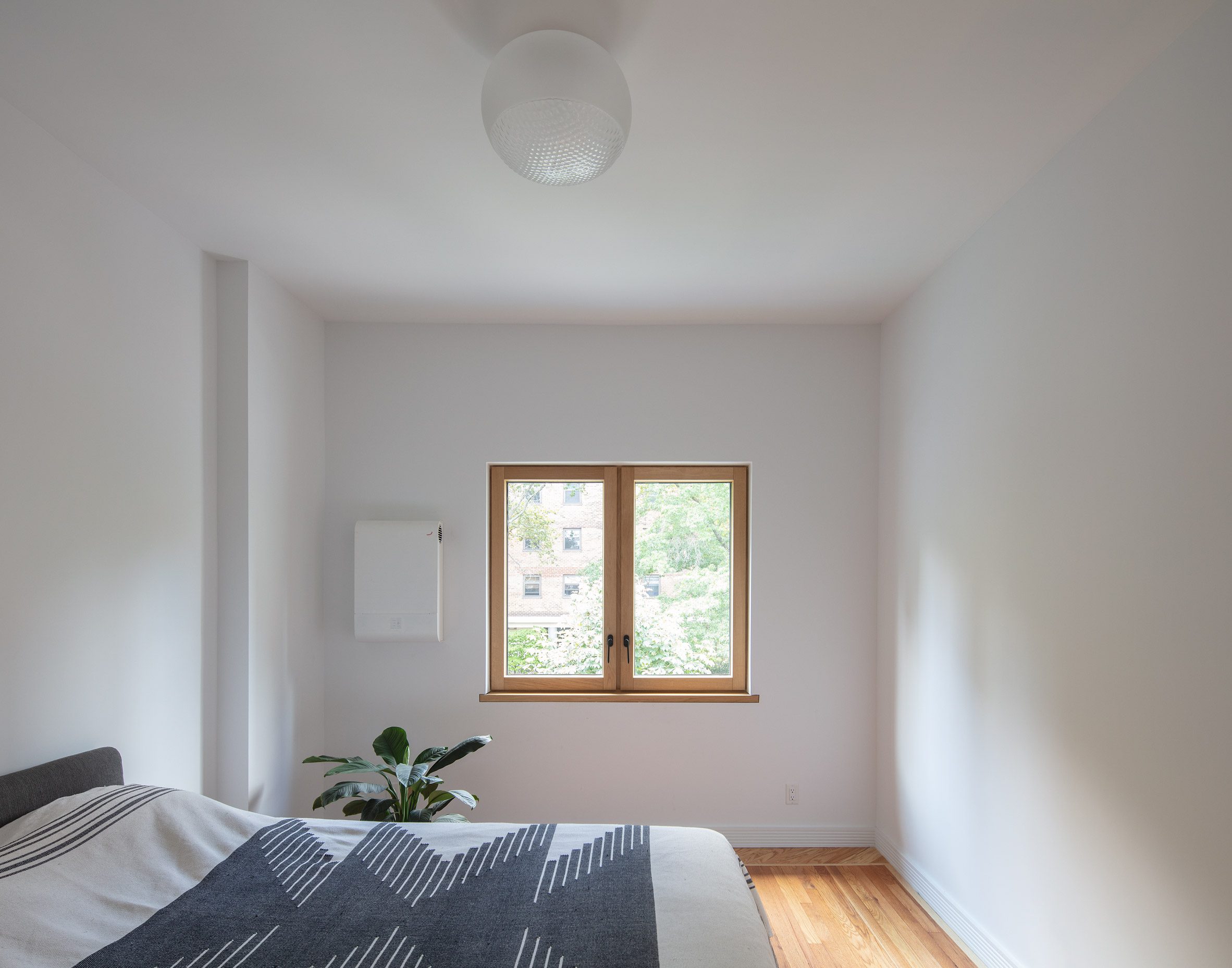 Minimal bedroom containing an energy recovery ventilator system
