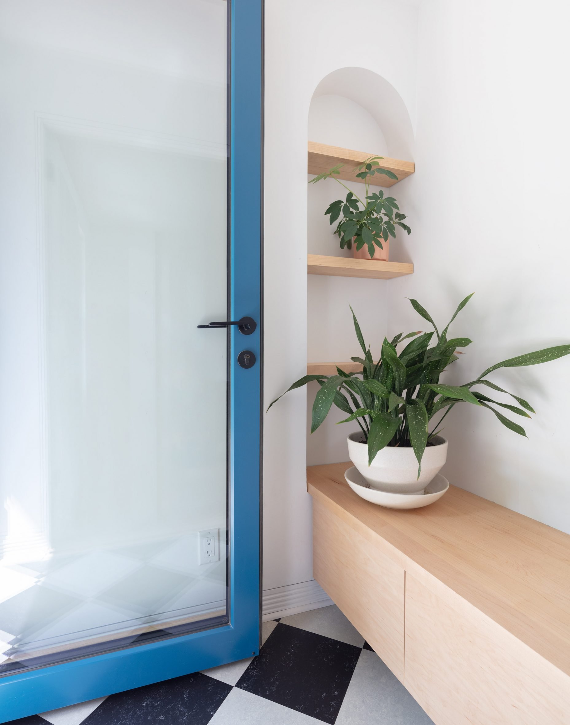 Glass door with bright blue frame open into an interior