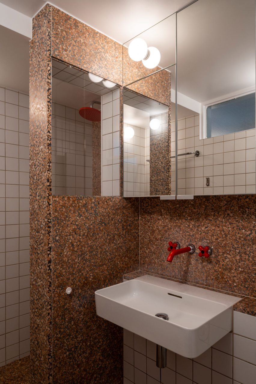 Bathroom with red taps and terrazzo in Trellick apartment by Archmongers
