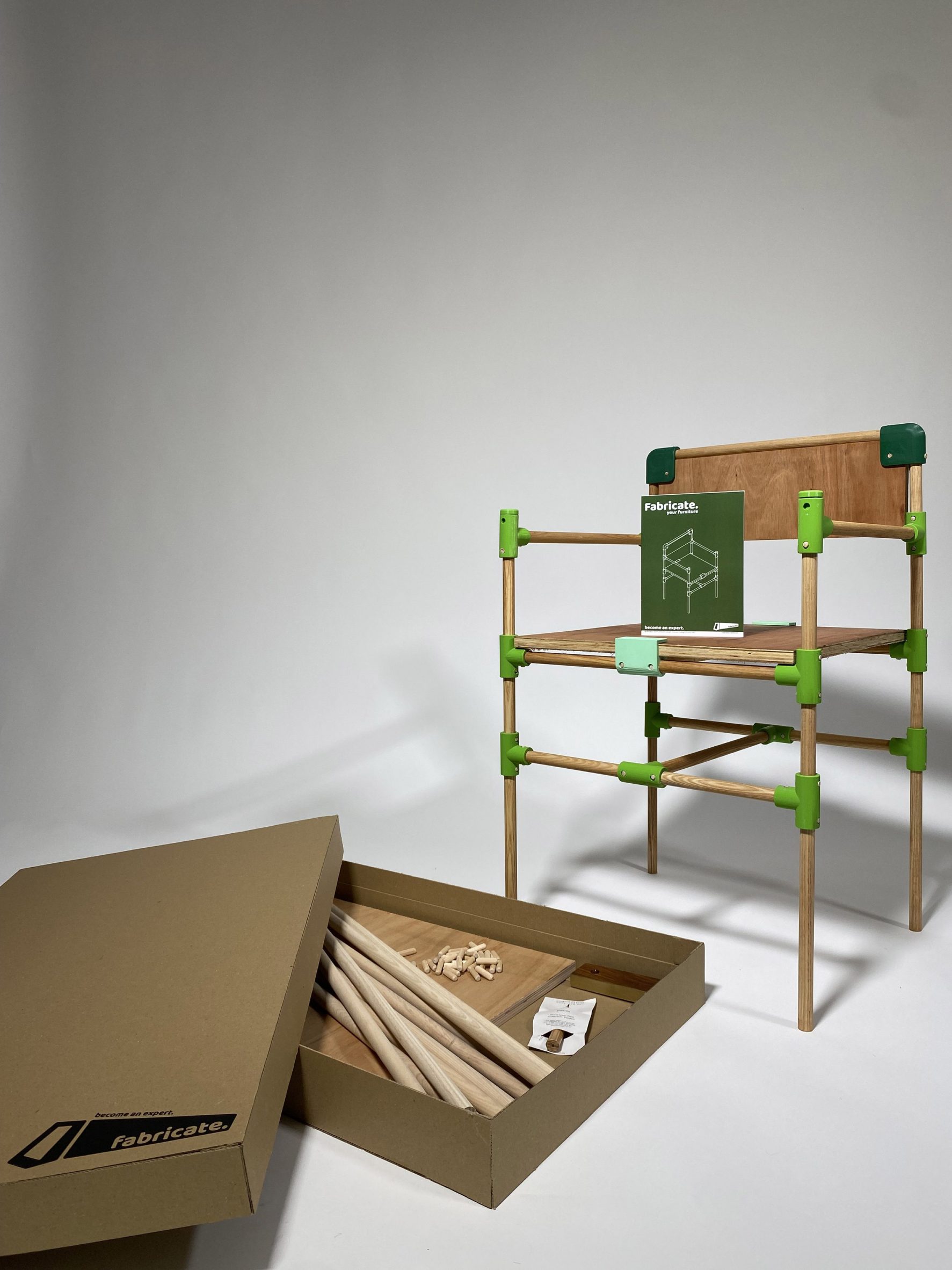 Photograph of a chair in tones of brown and green against a grey backdrop