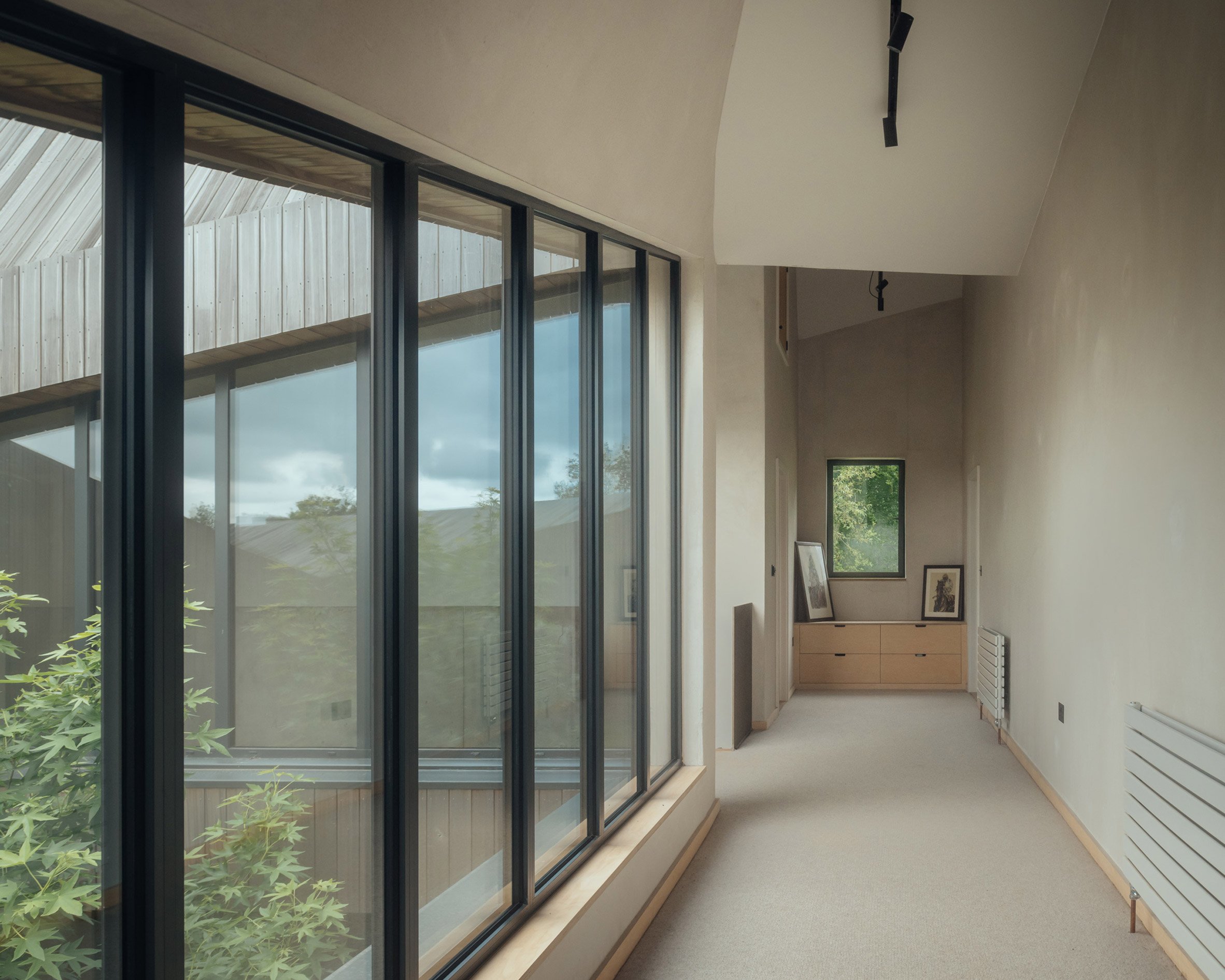 Upstairs corridor in a home overlooking a courtyard