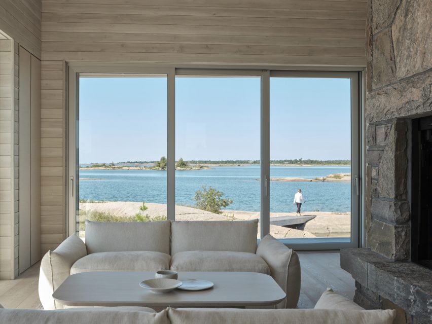 Living room with large sliding glass doors that provide a view of the water