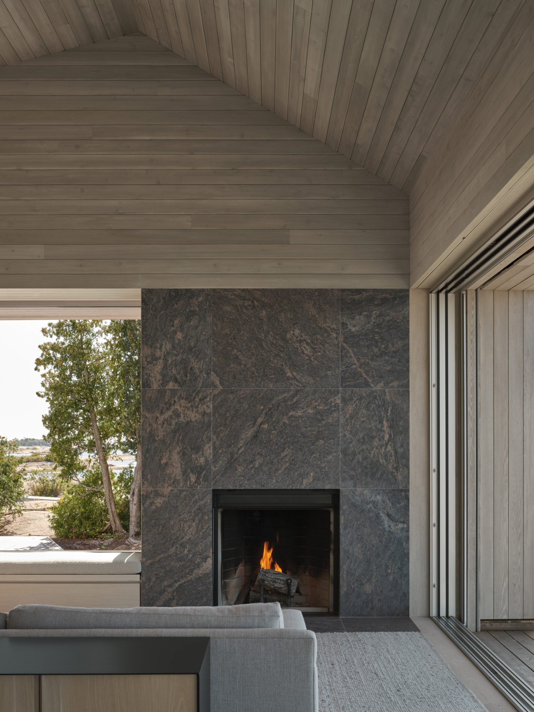 The communal area a cottage featuring a fireplace surrounded by Muskoka granite