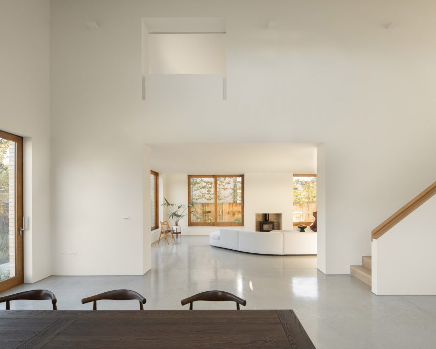 double-height dining room with white walls