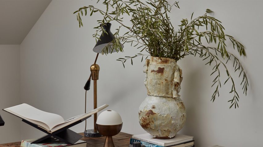 Photo of lamp and vase on a desk