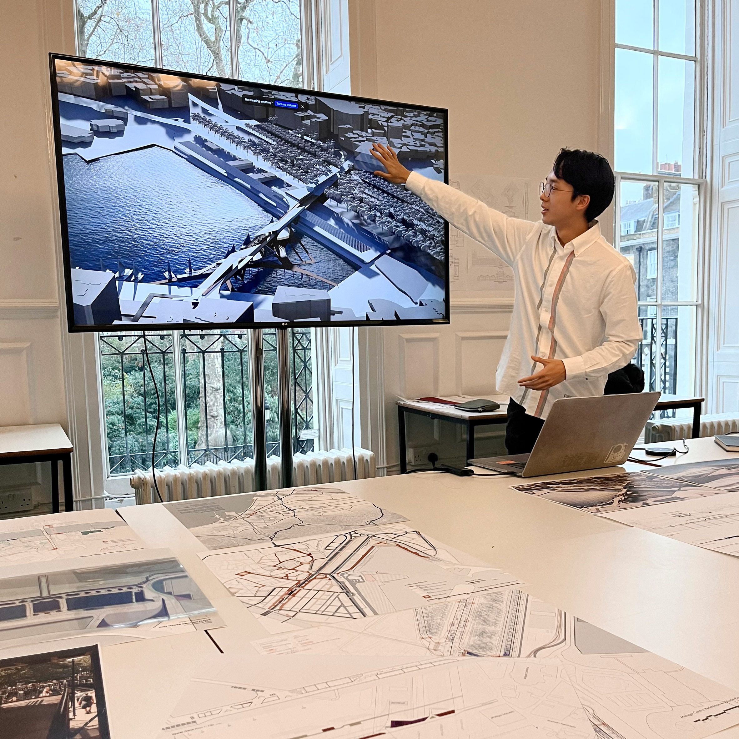 Student presenting in front of large screen