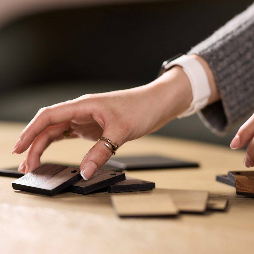 a photograph of a person arranging tiles