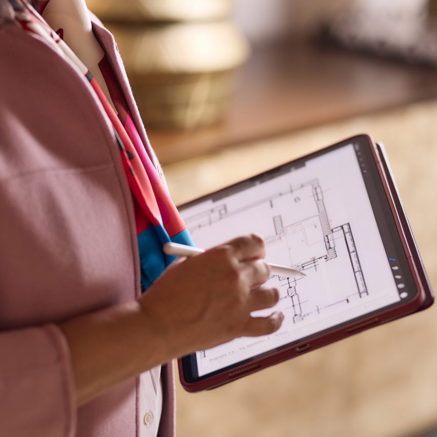 a photograph of a person using an electronic tablet
