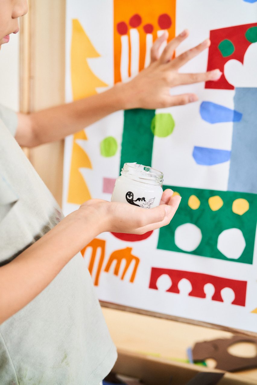 Child using glue in a jar from Woset