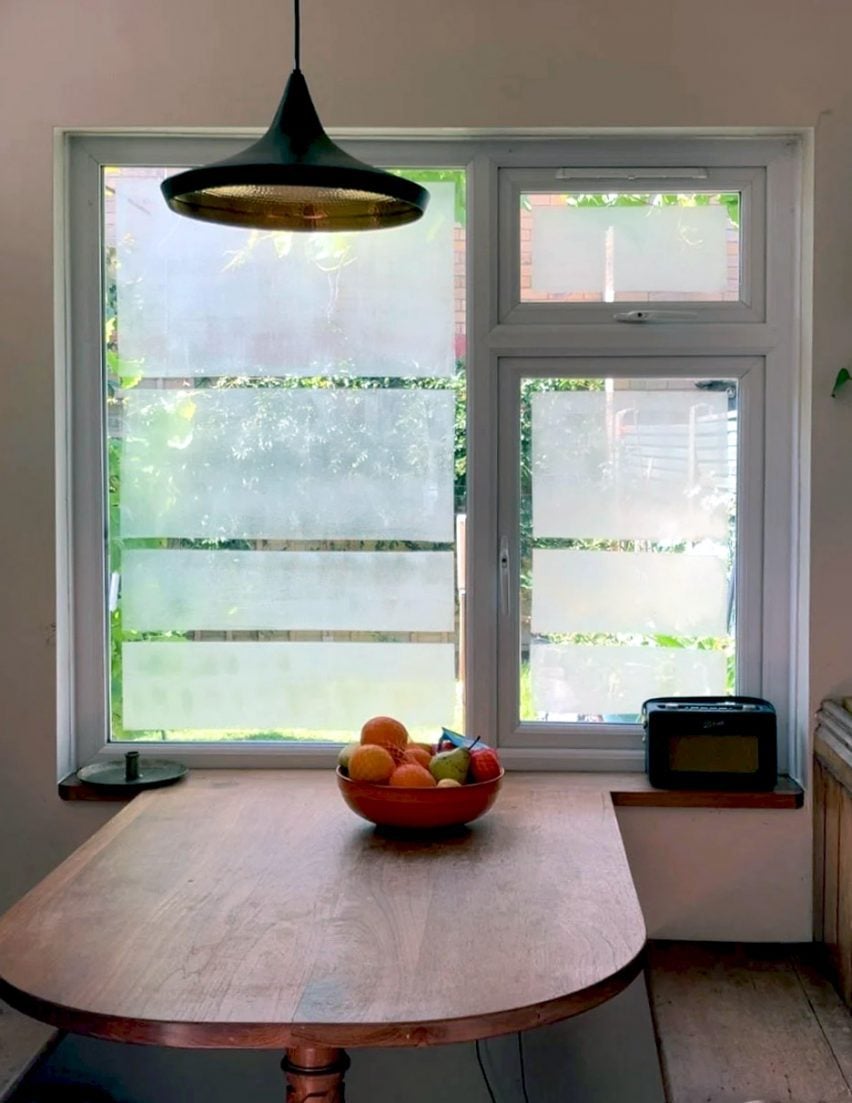 Photo of a large window inside a house covered with a translucent coating