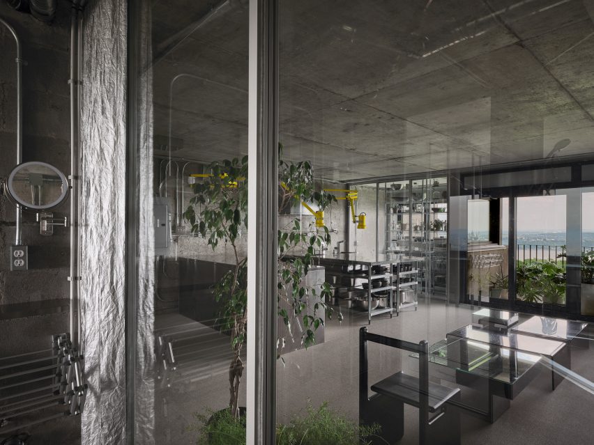 Glass partitions dividing concrete apartment