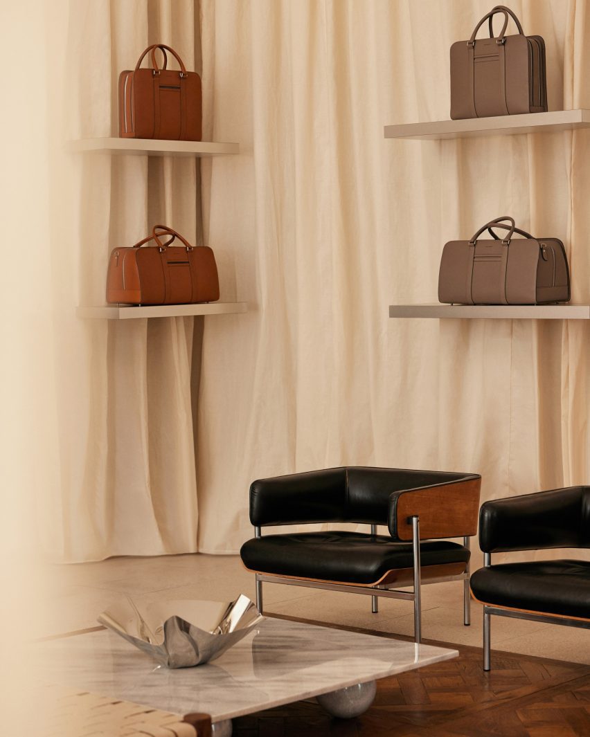 Close-up of leather chairs around a marble table