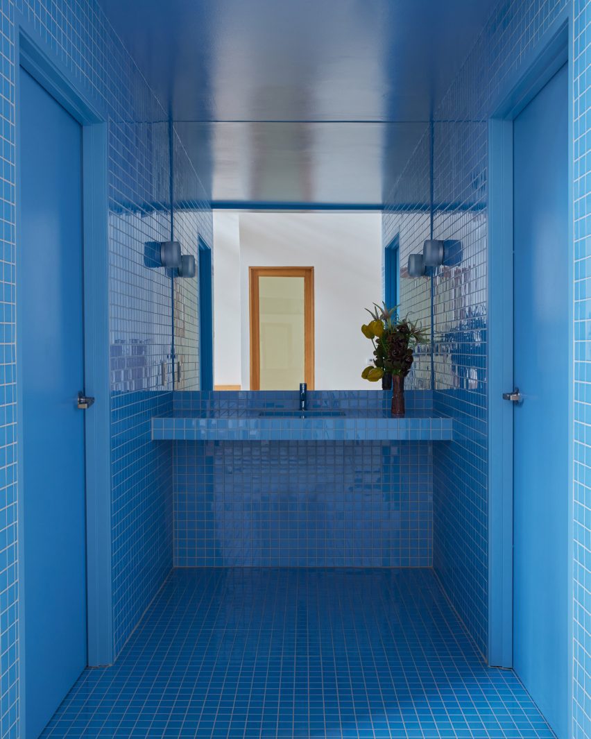 Bathrooms enveloped floor to ceiling in vibrant blue