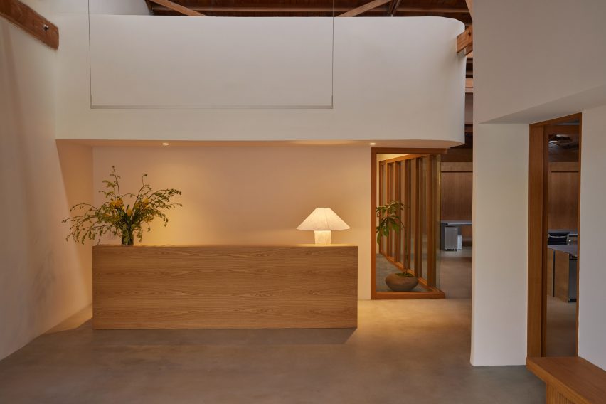 Office reception area with minimalist white oak counter 