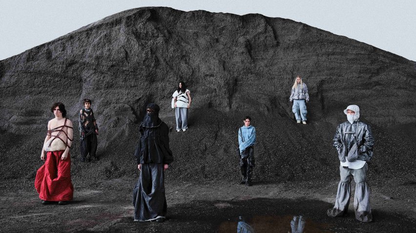 A photograph of seven people modelling a student fashion collection against a backdrop of a black cliff and black sand.