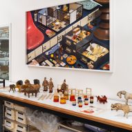 A desk with items underneath and painting on wall