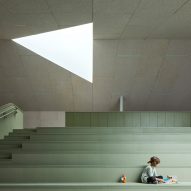 Kid sitting on pastel colored chairs