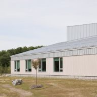 School building with light coloured siding