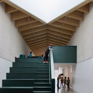 Wood ceiling and dark green stairs