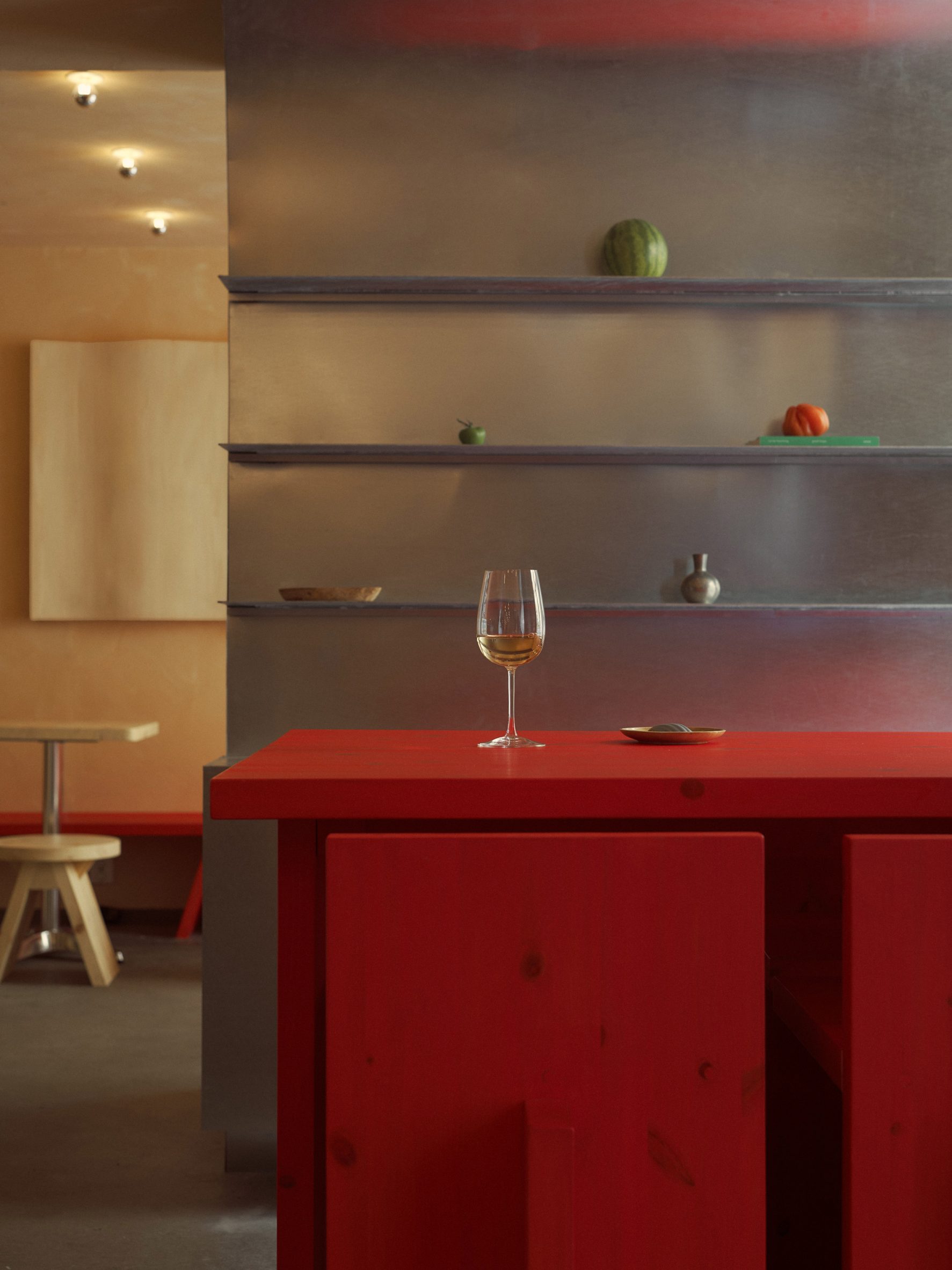 Steel shelving and red table