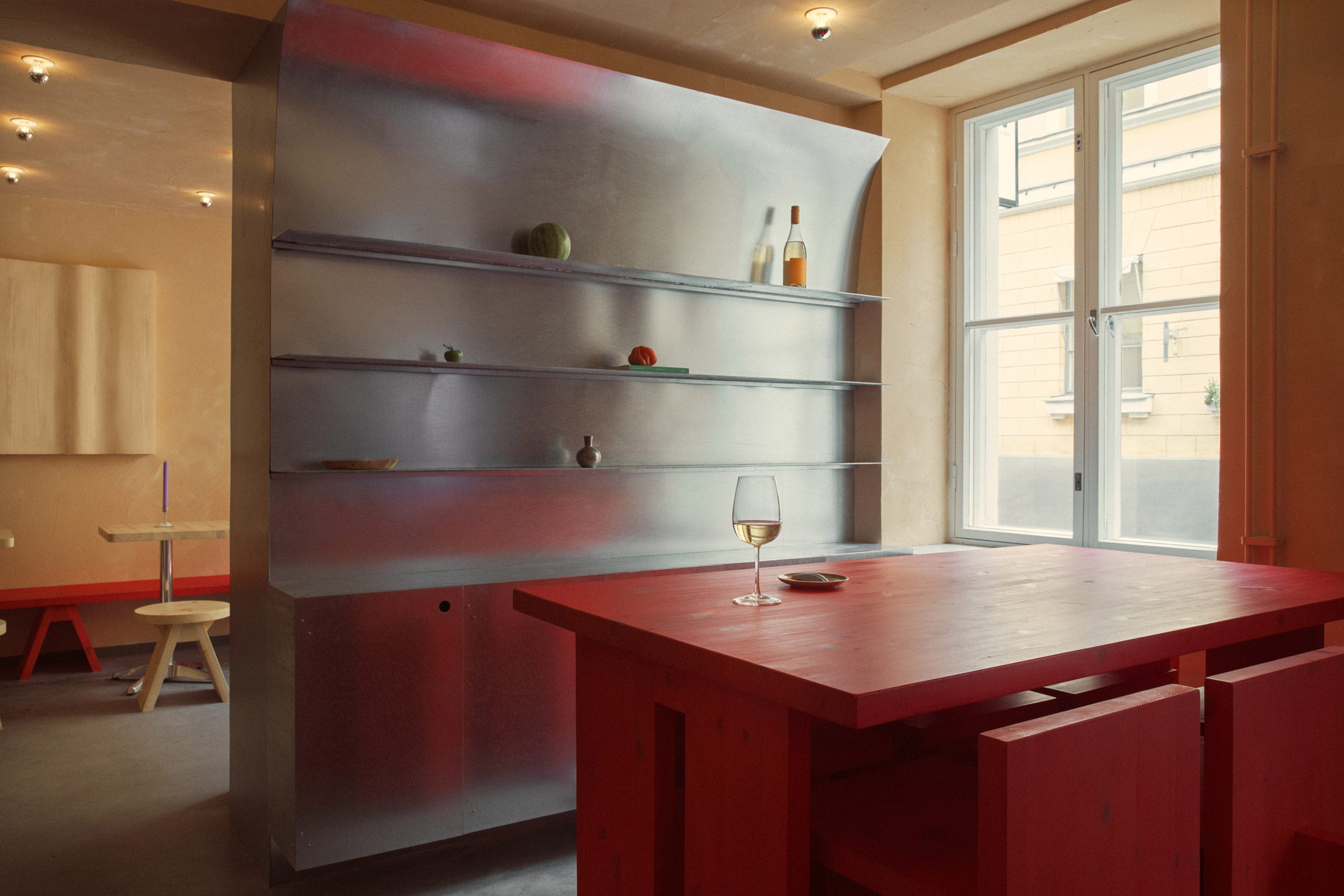 Curved steel shelving in El Fant Café and Bar