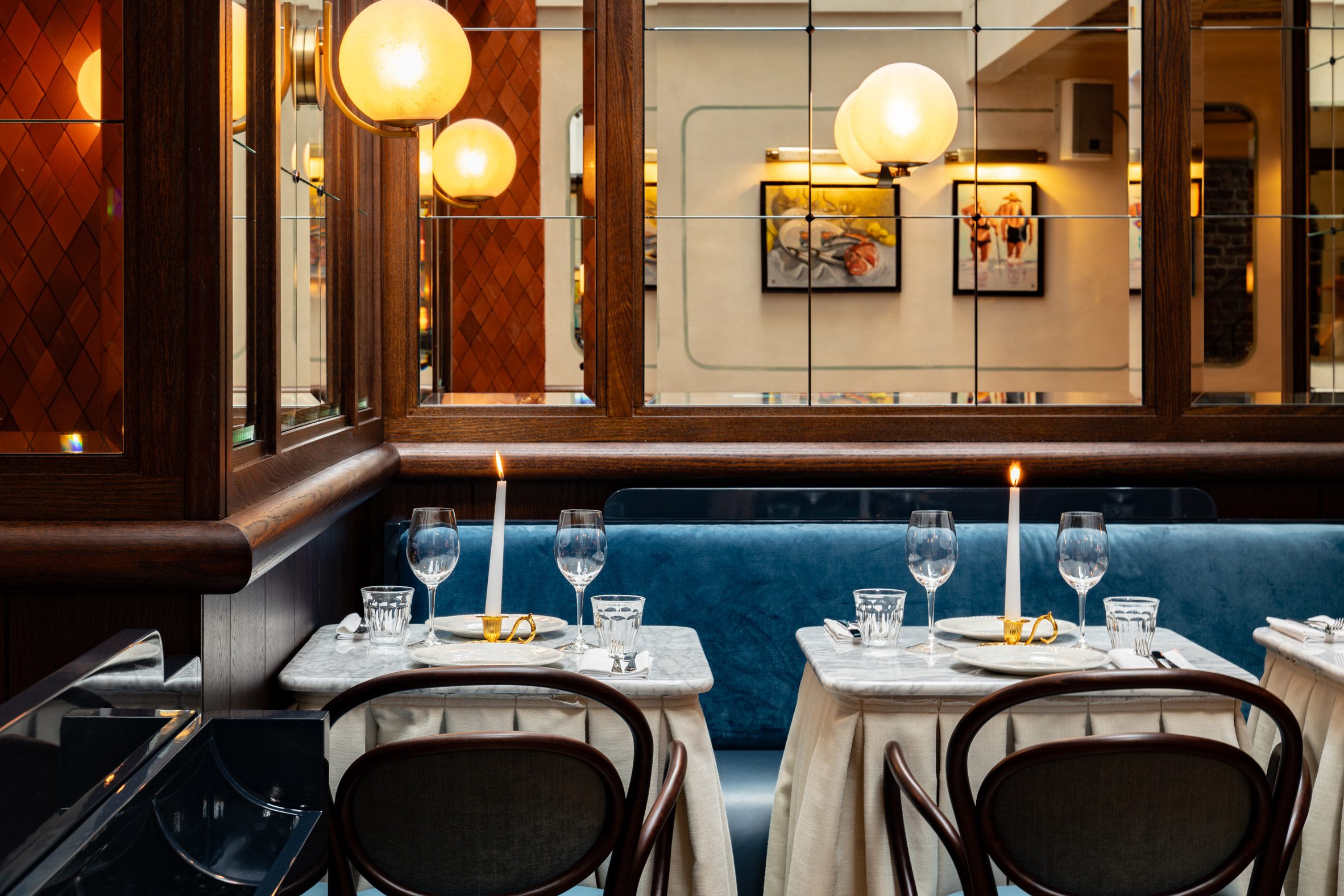 Tables and mirrors inside London eatery by Dorothee Meilichzon
