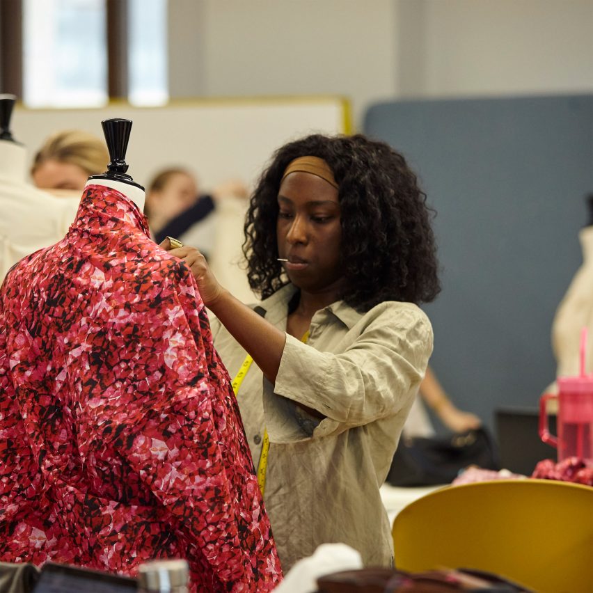 a fashion student working on their design on a mannequin