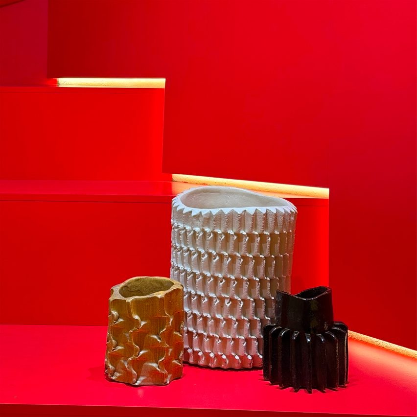 an image of three vases on a red backdrop