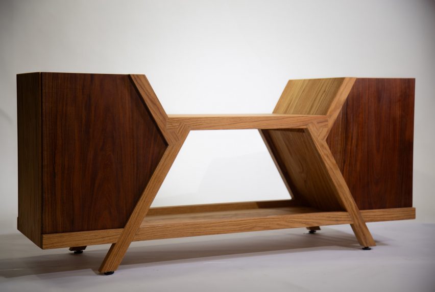 A geometric, abstract-shaped wooden table against a white backdrop.