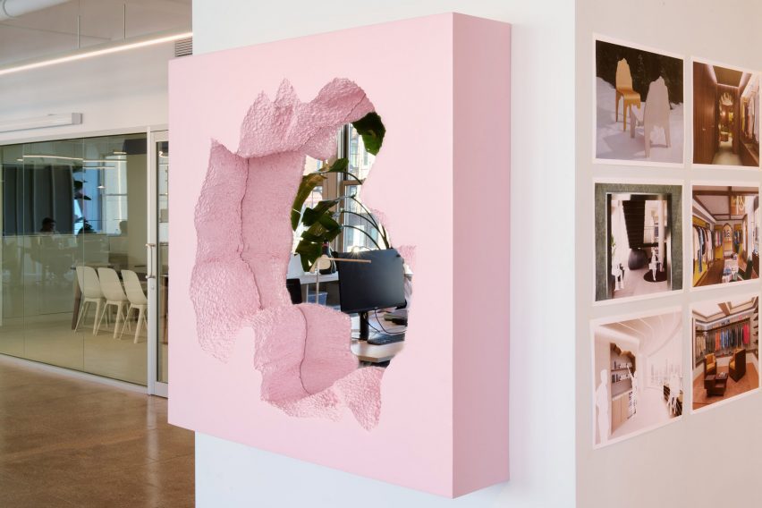 Mirror with pink frame mounted on a wall