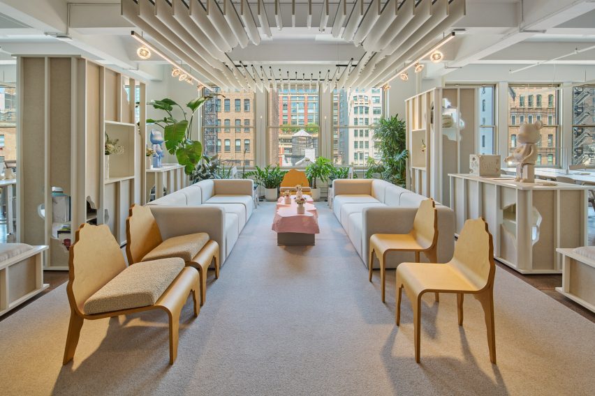 Lounge area with sofas and chairs facing each other in front of windows