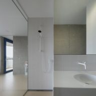 Glass-walled bathroom with white fittings and fixtures