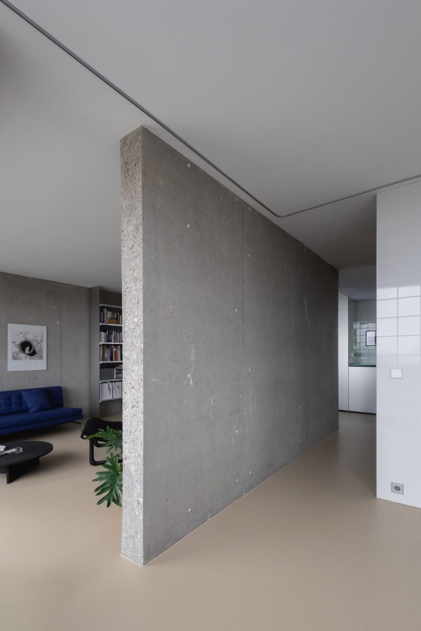 View of a concrete wall with living area on the far side