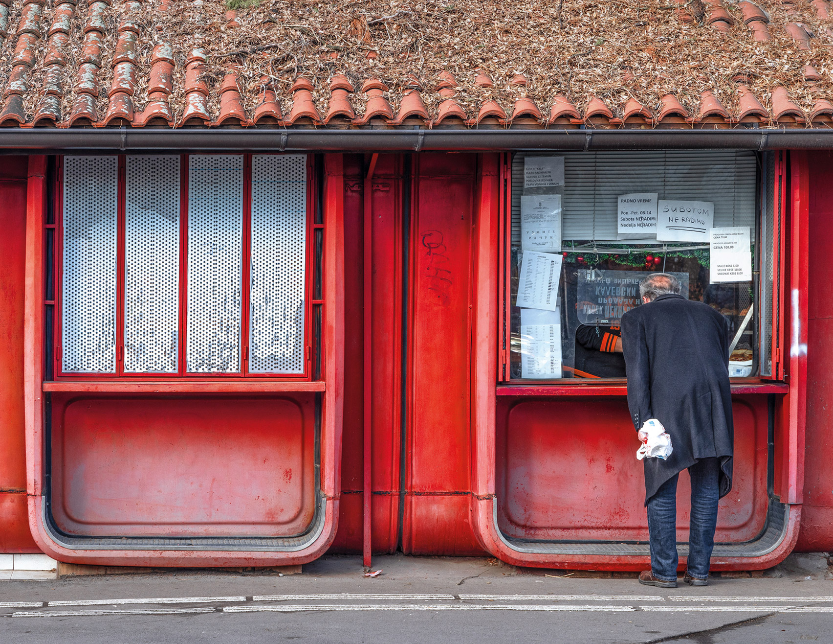 Man at a modernist kiosk in Serbia