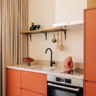 Orange kitchenette in rooms by Post Company