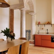 Archways and burnt orange kitchenette in hotel room