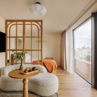 Glass and wood screen dividing living space from bed