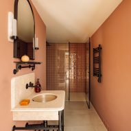 Earthy pink walls and Portuguese stone in bathroom Locke hotel