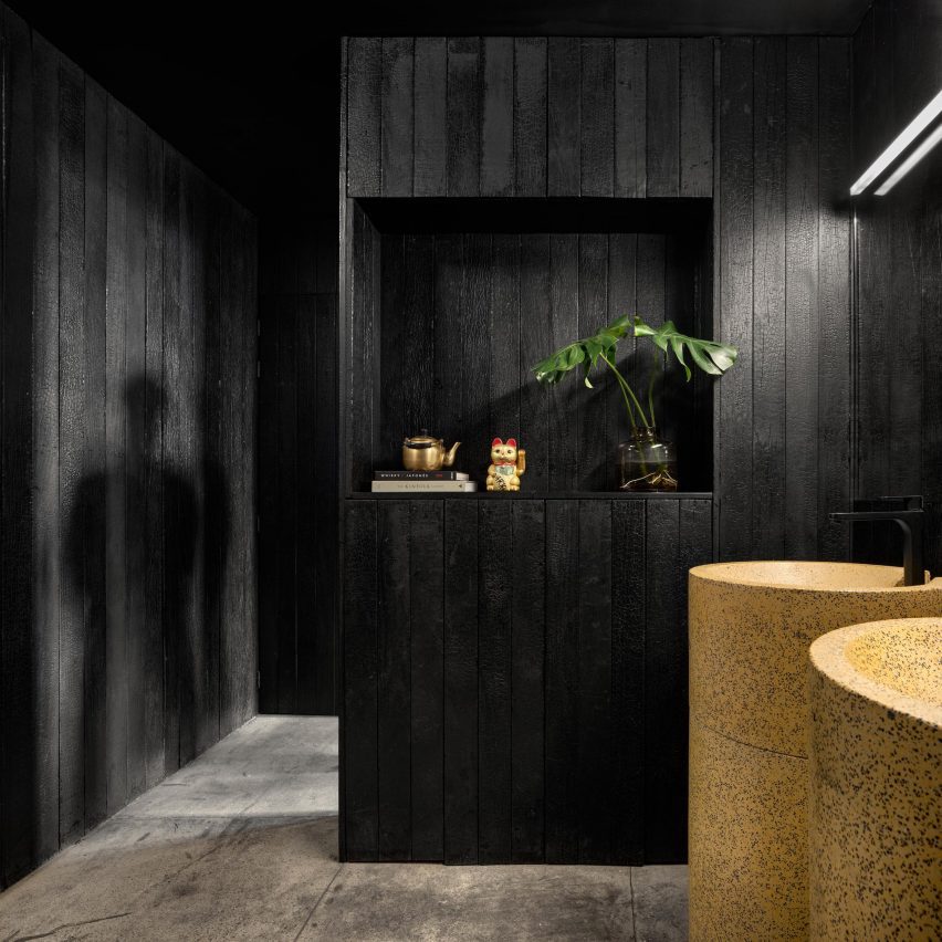 Charred wood lining bathroom walls