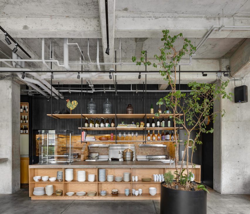 Open kitchen framed by exposed concrete structure