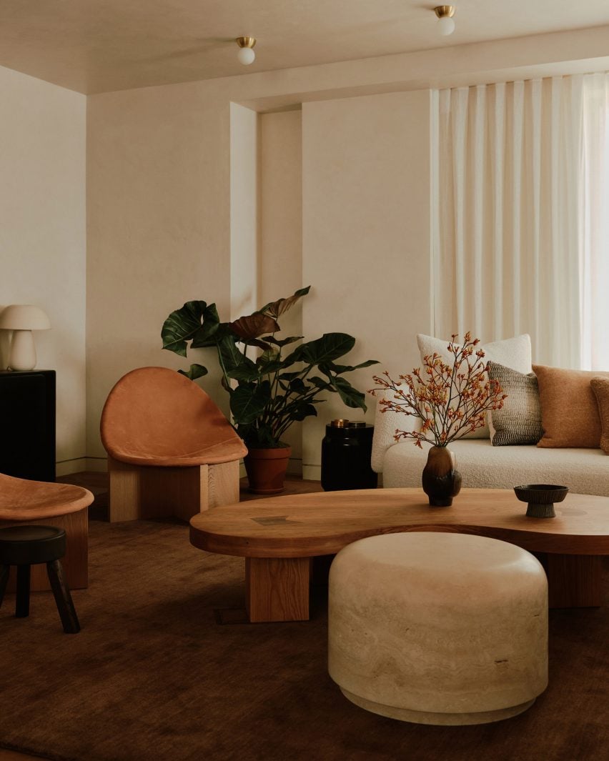 Wooden and travertine sofa tables in Manhattan flat