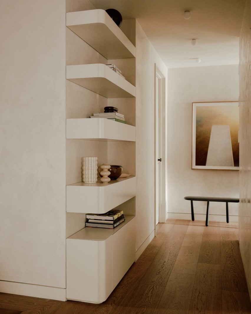 White built-in shelves and wooden floor in New York flat