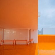 Orange floors create "golden afterglow" in Aranya fashion store by Say Architects