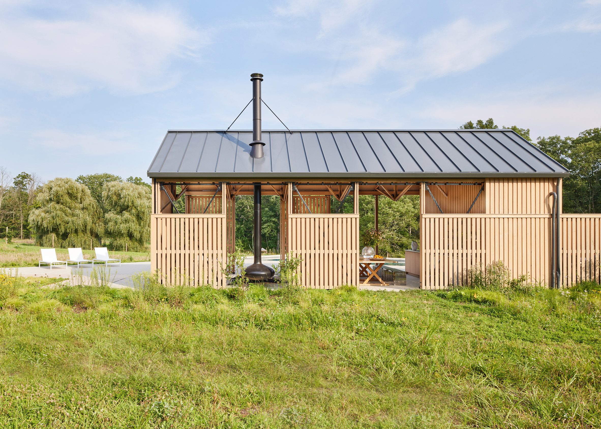 Side view of timber pool house with metal roof