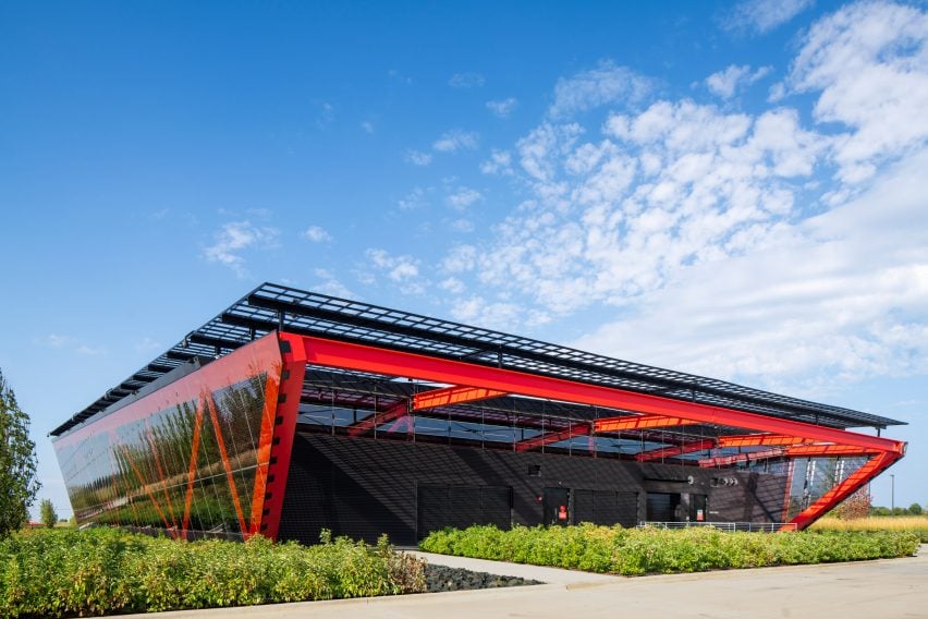 Red steel building with steel grid overlaid on top